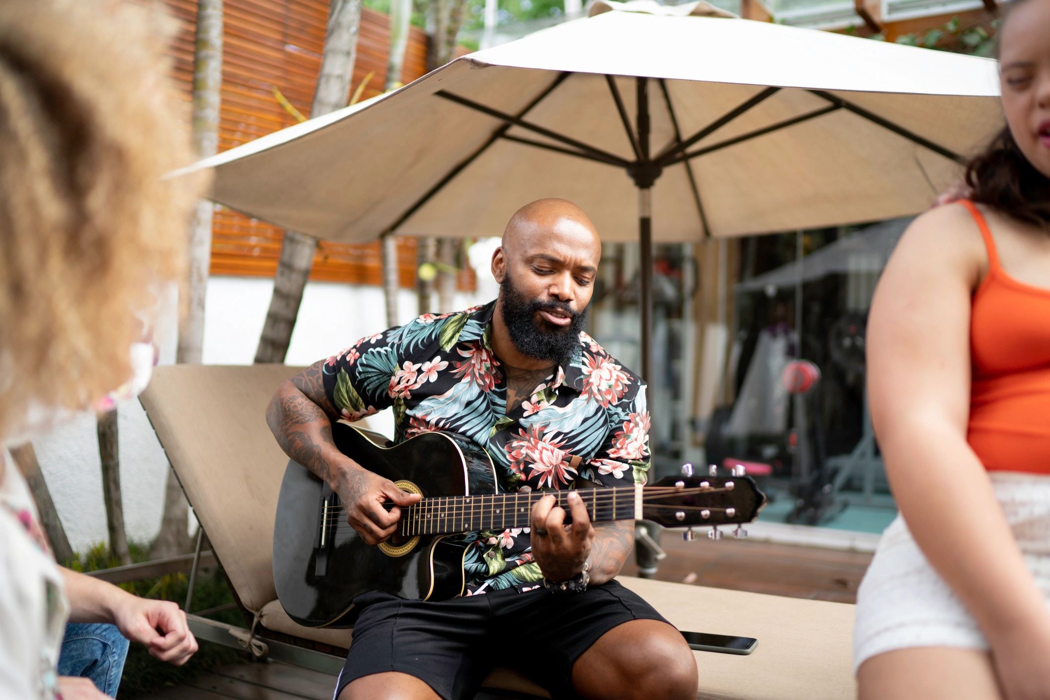 Friends and family gathered outdoors singing music together